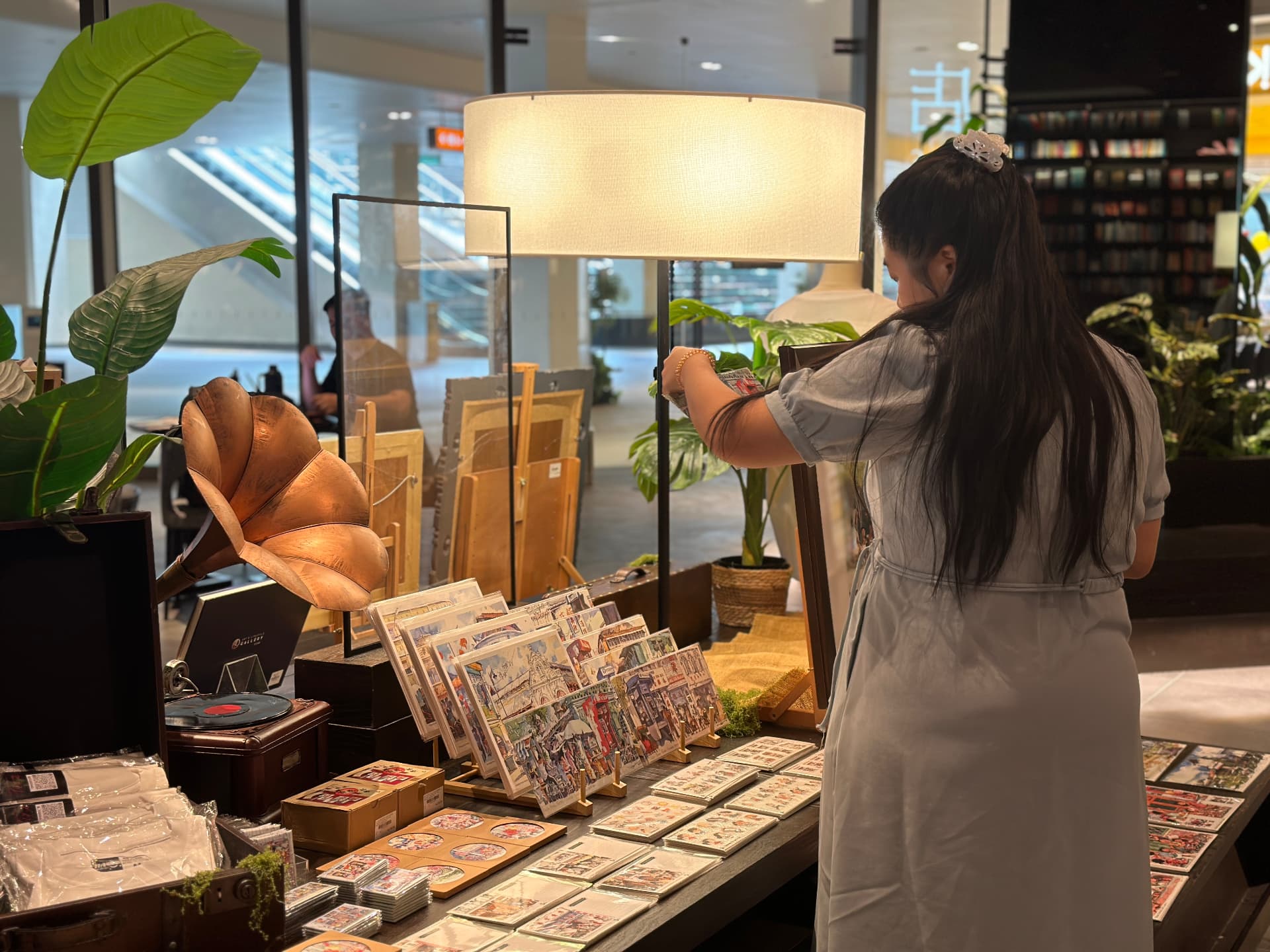 Visitor browsing art prints at the pop-up